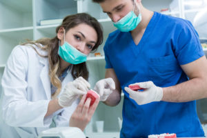 Doctor and assistant working on dental implants