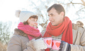 Couple toasting their hot cocoa in the cold outdoors