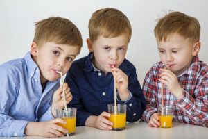 Kids drinking OJ