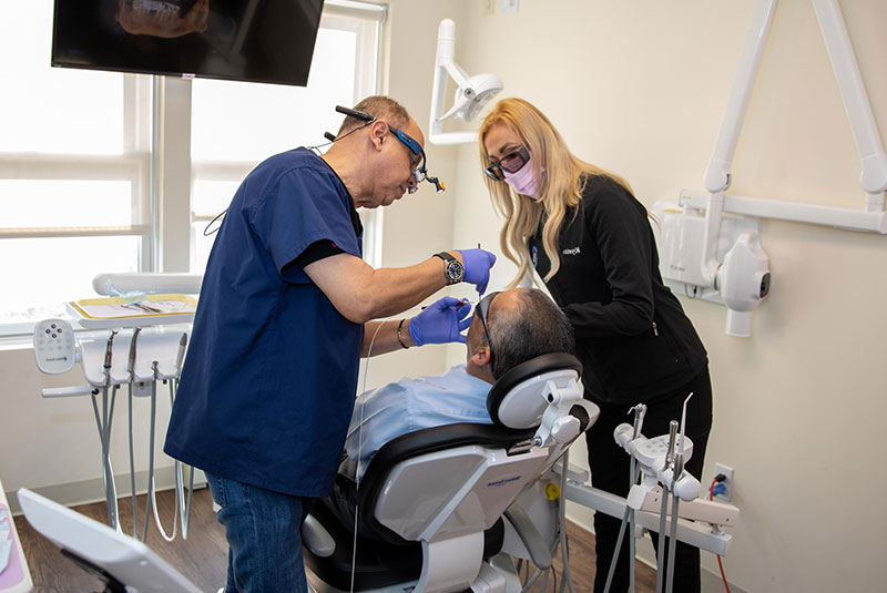 Doctor performing dental procedure with patient in operating room